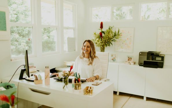 Leah Klasovsky of Leahlani Skincare sitting at her desk