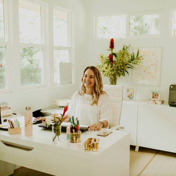 Leah Klasovsky of Leahlani Skincare sitting at her desk