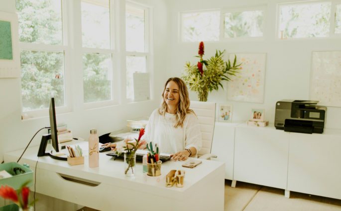 Leah Klasovsky of Leahlani Skincare sitting at her desk