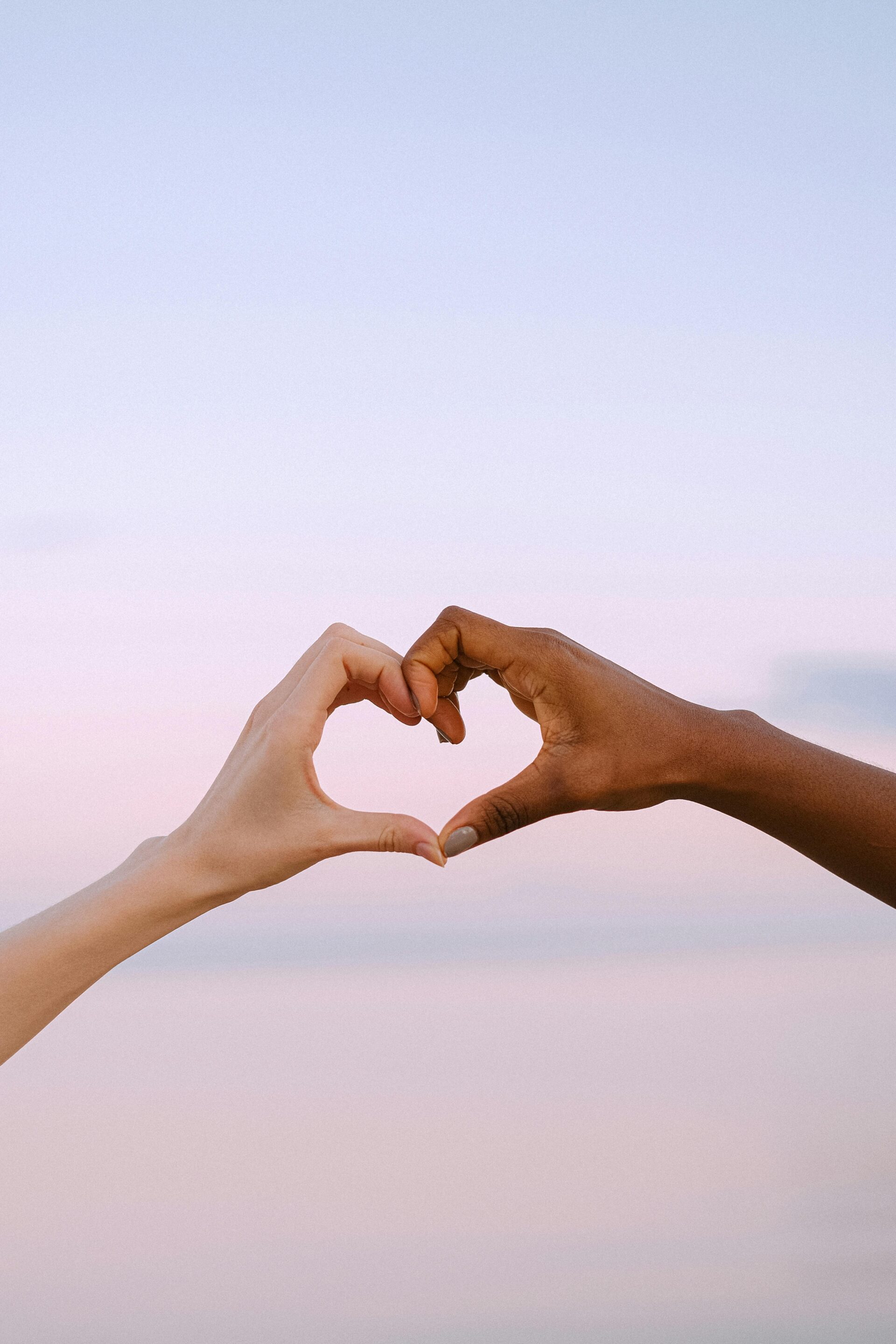 Two Hands Forming an Interracial Heart by Shvetsa on Pexels